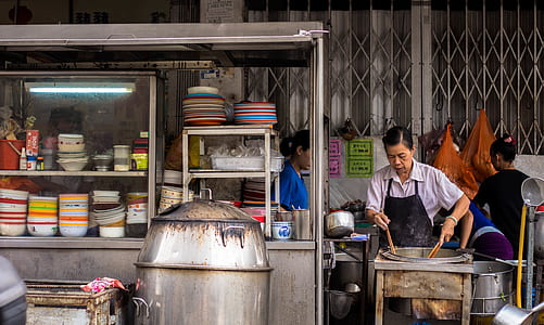 woman cooking in food stall thumbnail