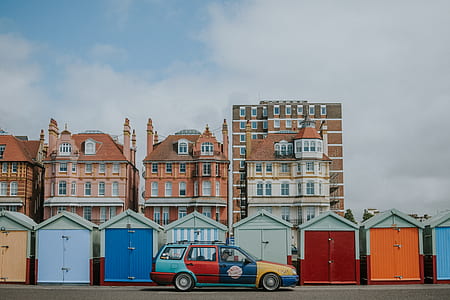 multicolored station wagon parked near buildings thumbnail