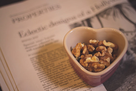 red and white heart-shaped bowl with brown nuts thumbnail