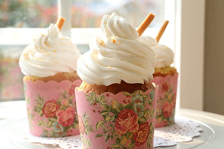 three cupcakes with white toppings thumbnail