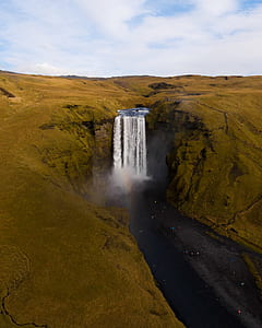 waterfalls between rock formation thumbnail
