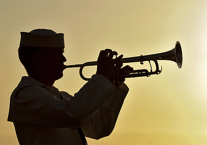 silhouette of man playing wind instrument thumbnail