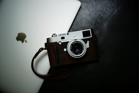 flat lay photography of black and gray bridge camera on silver MacBook thumbnail