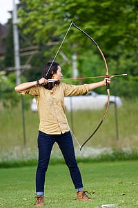 woman holding arrow and bow during day thumbnail