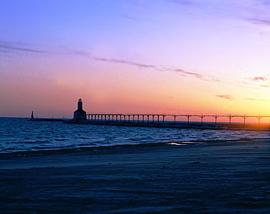 silhouette of lighthouse during golden hour thumbnail