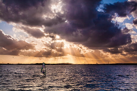 person windsurfing during golden hour thumbnail