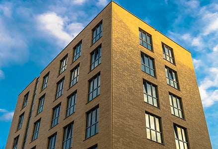 gray concrete building under cloudy sky thumbnail