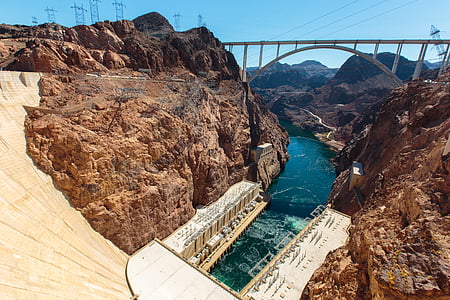 brown dam and bridge under blue sky thumbnail