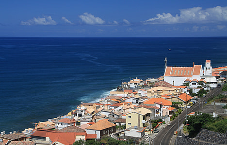 aerial photography of houses beside body of water at daytime thumbnail