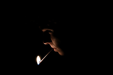 person with safety match stick in mouht thumbnail