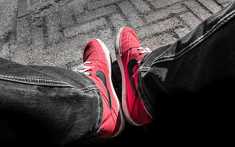 pair of red-and-black Nike sneakeres thumbnail