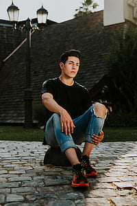 man sitting on stone thumbnail