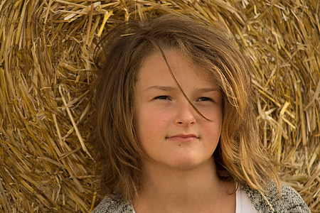 woman in gray top with hay background thumbnail