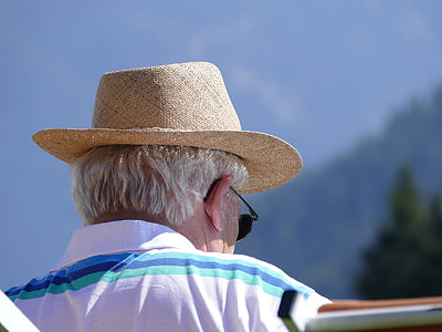 selective focus photography of man wearing white and blue striped collared top during daytime thumbnail