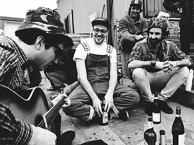 grayscale photo of man playing guitar thumbnail