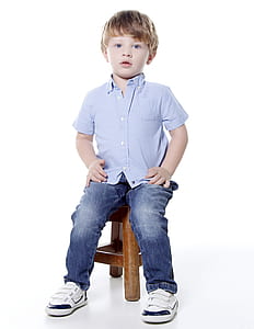 boy sitting on brown wooden stool thumbnail