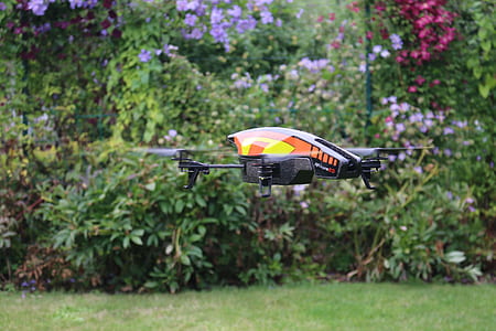 orange, white, and black quadcopter thumbnail