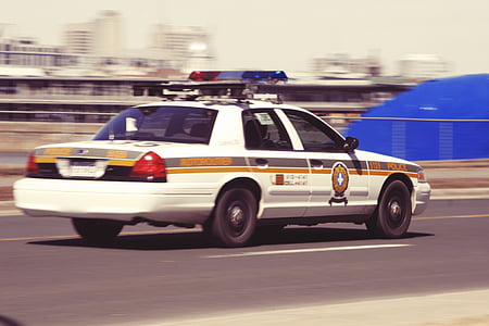 white and gray police car on road during daytime thumbnail