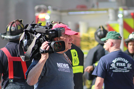 man carrying professional video camera thumbnail