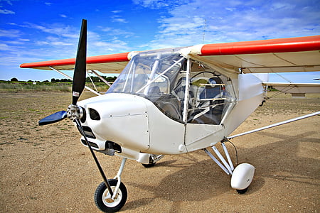 white and orange plane on brown ground thumbnail