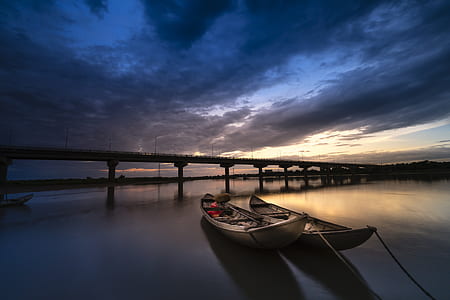 two gray canoes near bridge thumbnail