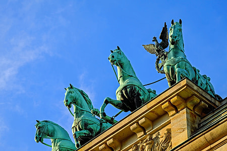 three copper statue of horses on top of arch thumbnail