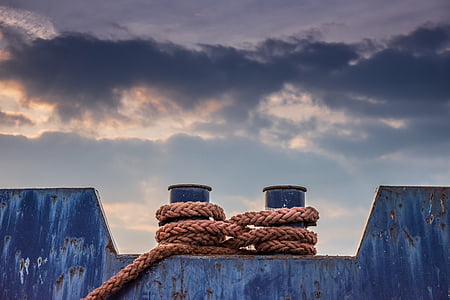 brown rope on steel bar during daytime thumbnail