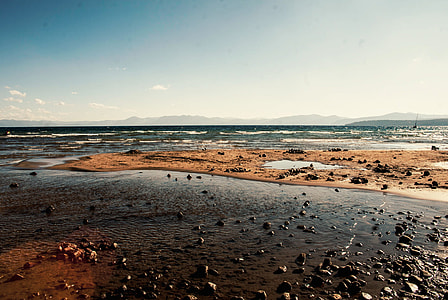 landscape photography of seashore with stones thumbnail