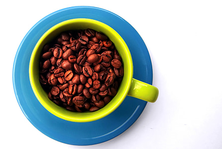 coffee bean in green ceramic mug on blue ceramic saucer thumbnail