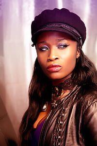 woman wearing black leather jacket and purple hat thumbnail