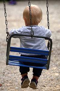 baby sitting on swing chair thumbnail