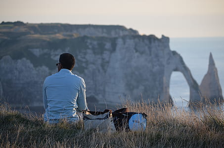 man sitting on grass thumbnail