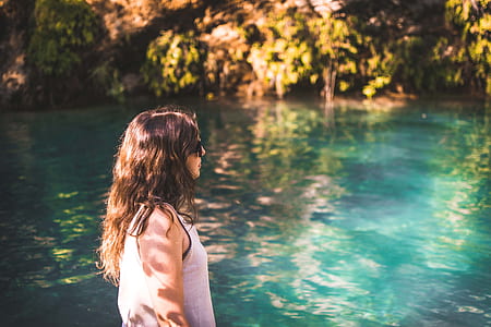 woman standing near body of water thumbnail