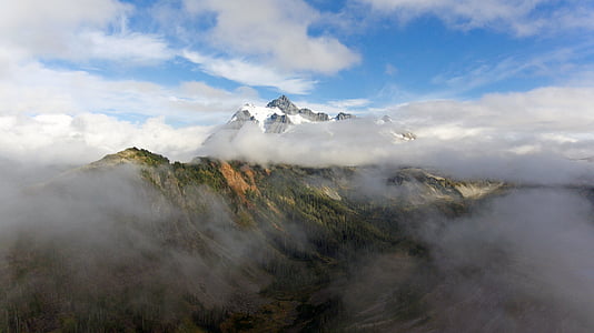 mountain covered by clouds during daytime thumbnail