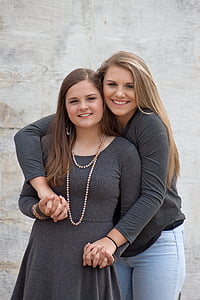 two smiling woman wearing gray long-sleeved blouse and dress thumbnail