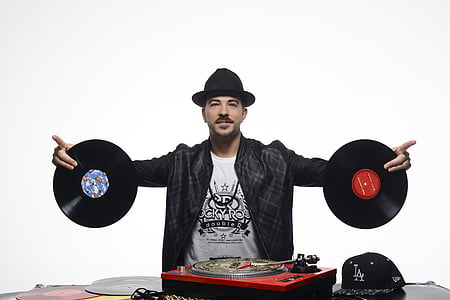 man holding two vinyl records thumbnail