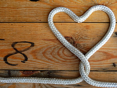 flat lay photography of heart formed white rope thumbnail