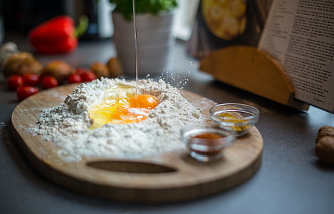 selective focus photography of raw egg surrounded by flour thumbnail