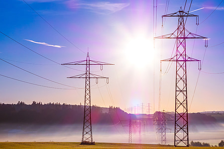 black electric towers under blue sky during daytime thumbnail