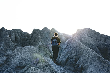 photo of man walking on mountain thumbnail