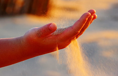 person with sand on hand thumbnail
