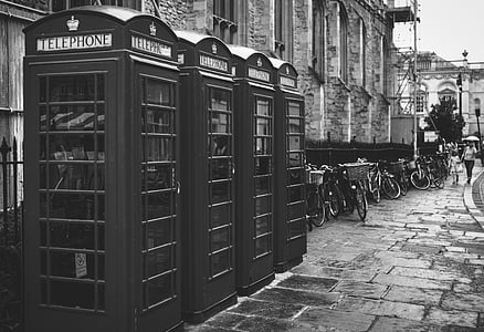 four telephone booths on sidewalk thumbnail