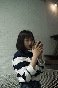 Photo of Woman Wearing Black and White Stripe Top thumbnail