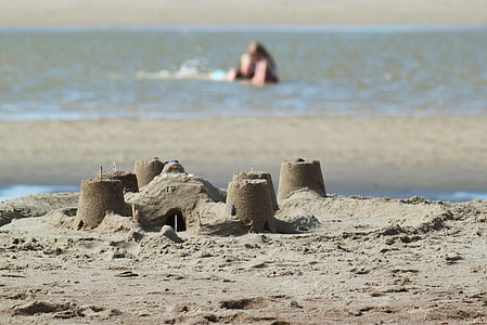 person on body of water near seashore thumbnail