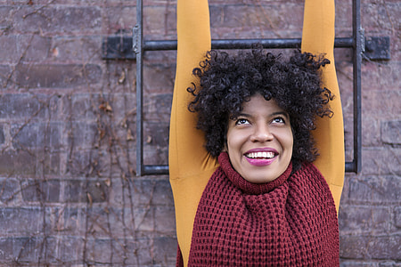 women's wearing yellow and maroon shirt thumbnail