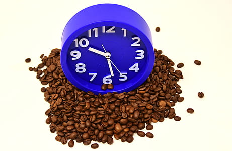 blue analog clock on coffee beans thumbnail