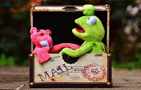 Kermit the Frog and Pink Panther plush toys in beige and brown basket thumbnail