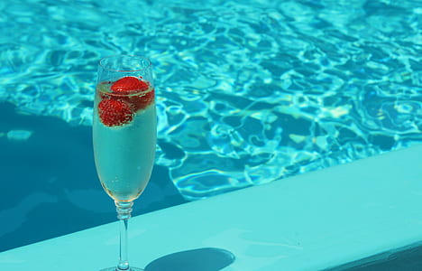 clear flute glass beside body of water thumbnail
