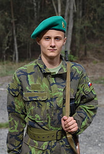 man in military suit standing holding rifle thumbnail
