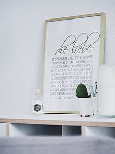 white quote board on table in front of white painted wall thumbnail